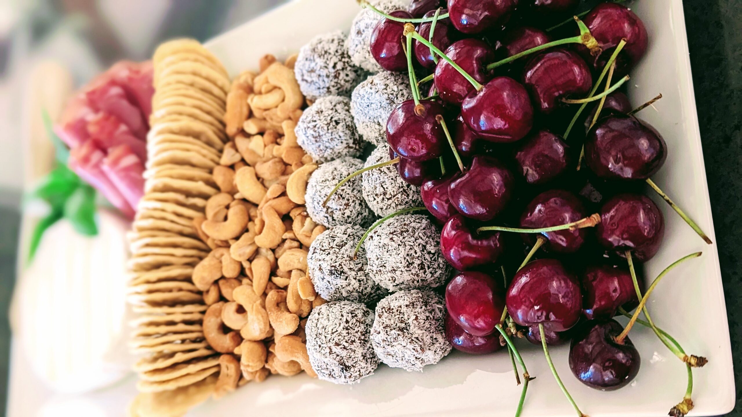 A platter of Christmas treats from the fridge, pantry, and fresh cherries.